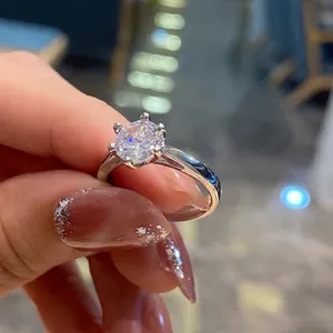 Detailed close-up of a six-prong solitaire ring with a brilliant round-cut diamond