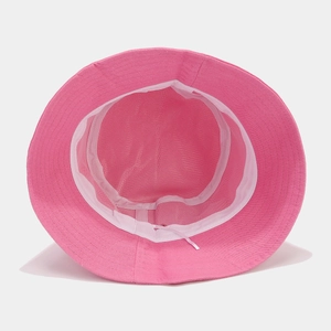 Pink patchwork bucket hat for sun protection with adjustable drawstring and interior detail