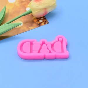 Pink DAD silicone mold for Father's Day baking and resin crafts on blue background
