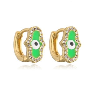 Detail of 18K gold Hamsa Hand earrings with green enamel and evil eye zircon stones