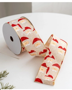 Detailed view of Christmas ribbon with Santa Claus prints and golden wire edges