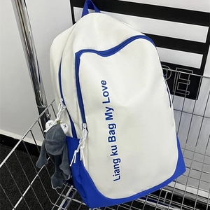 Minimalist blue and white school backpack with large capacity and plush pendant in basket
