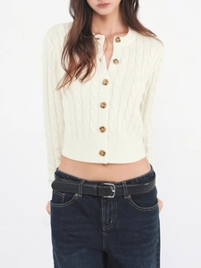 Slim fit cream cable knit cardigan sweater for women paired with dark blue denim jeans