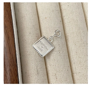 Close-up of S925 sterling silver heart pendant with Me + You engraving in a jewelry box