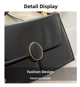 Détail du sac à main en similicuir noir montrant la boucle magnétique dorée et couture