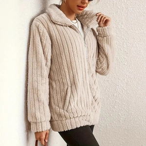 Detail view of beige fleece jacket showing vertical texture and zipper stand collar