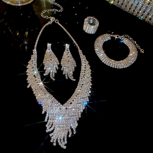 Luxury V-shaped rhinestone jewelry set including necklace and earrings on black background