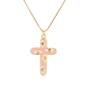 Detail of 18K gold-plated cross pendant with pink enamel eyes and amber zircons