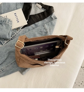 Detailed macro view of brown corduroy bag interior with tablet showing large storage space