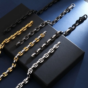Detailed view of coffee bean link bracelets in gold, silver, and black on a display box