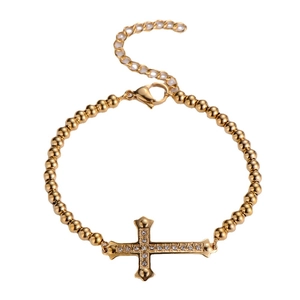 Gold beaded titanium steel bracelet with sparkling zircon cross pendant on white background