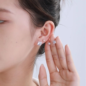 Square and round stainless steel stud earrings with blue cubic zirconia on female model