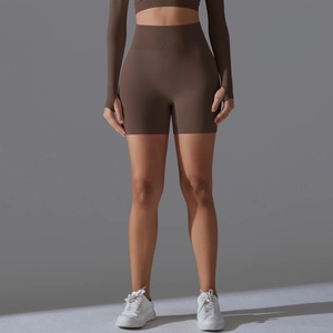 Detail of high waist seamless yoga shorts and long sleeve crop top set in dark brown