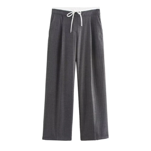 Close-up of charcoal grey wide leg trousers featuring a white drawstring and twill texture
