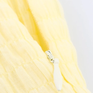 Yellow textured crepe dress featuring a high-quality invisible zipper and pleated fabric