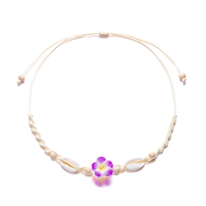 Bohemian woven shell necklace with purple frangipani flower for beach vacation style