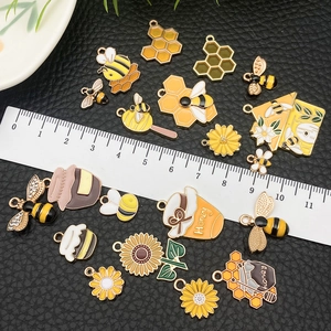 Assorted honeybee alloy charms in yellow and gold for DIY jewelry making with ruler scale