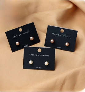 Three pairs of white, pink, and champagne freshwater pearl earrings on 925 silver studs