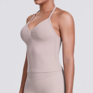 Detail of ruched front design and halter neck straps on a nude yoga sports bra top
