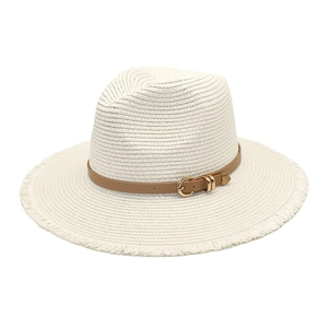 Close-up of beige woven straw hat featuring a brown leather belt with gold horseshoe buckle