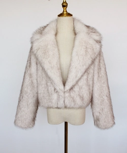 Detailed view of grey and white faux fox fur texture on a short lapel coat for women