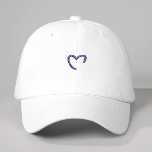 White cotton baseball cap featuring blue embroidered heart pattern on the front