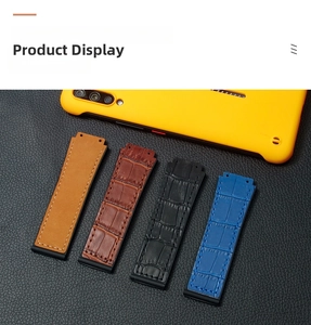 Detail view of leather textured watch straps in brown, black, and blue with rubber base