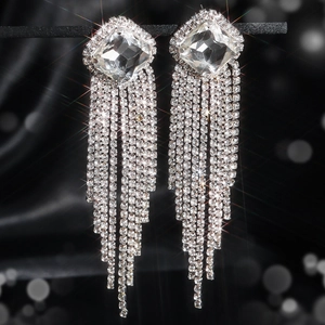 Close-up of luxury silver tassel earrings featuring square main diamond and crystal fringe
