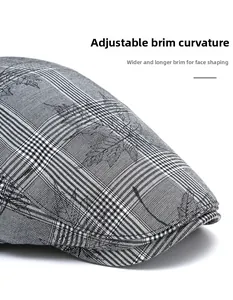 Detailed macro view of the grey plaid beret cap with maple leaf embroidery and foldable brim