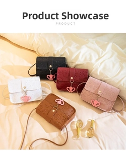 Detail view of five textured mini square bags with heart embossing and cute charms