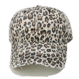 Close-up of leopard print baseball cap featuring distressed torn details on curved brim