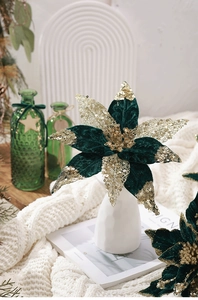 Detail of dark green velvet poinsettia with gold sequins for Christmas decoration
