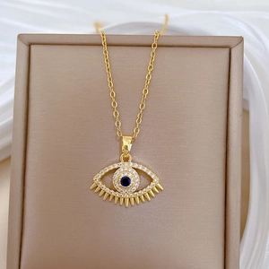 Gold evil eye necklace with blue gemstone and diamonds on a luxury display tray