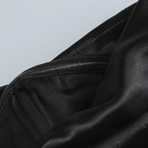 Detail of internal non-slip silicone strip on black PU evening dress bodice edge