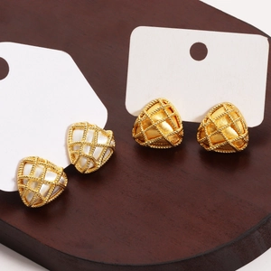 Detail view of gold-plated triangle stud earrings with textured mesh and white inlay finish
