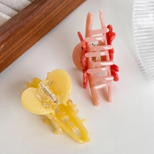 Elegant French style butterfly hair claws in pastel yellow and pink colors