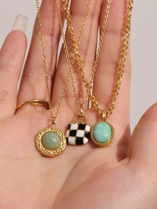 Detailed shot of retro checkerboard bag pendant and green natural stone necklace set