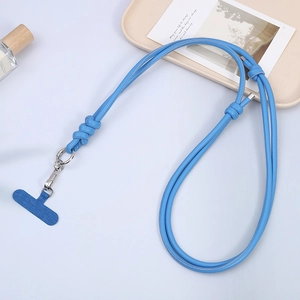 Sky blue leather phone lanyard with metal clasp and gasket on aesthetic tray