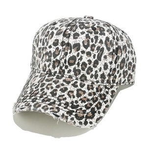 Detailed view of the distressed leopard print pattern and frayed edge on the baseball cap