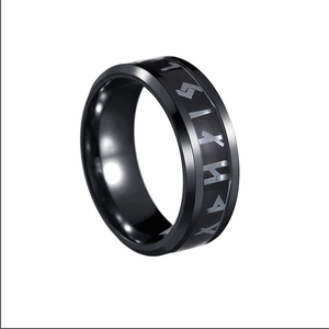 Macro shot of 8mm black titanium ring featuring engraved Celtic knot and Nordic rune motifs