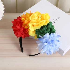 Macro shot of colorful fabric daisy flowers on a bohemian floral headband for vacations