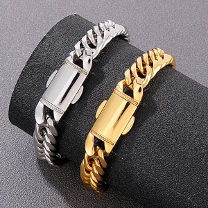 Polished silver and gold Cuban link bracelets displayed on a professional jewelry stand