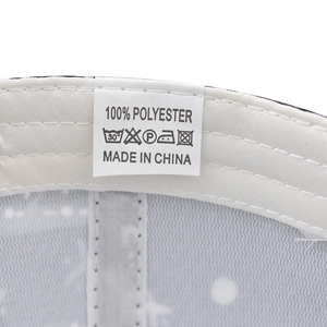 Detail shot of baseball cap interior showing 100% polyester mesh lining and care label
