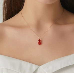 Close-up of red agate gourd pendant on a dainty gold necklace for women