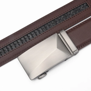 Detail of dark brown leather belt featuring a brushed metal automatic buckle and precision stitching