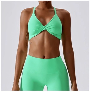 Detail of mint green yoga set featuring a twisted knot sports bra and high waist leggings
