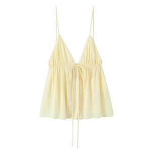 Light yellow spaghetti strap top with V-neckline and button details on white background