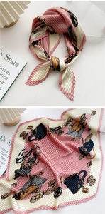 Detailed view of pink pleated silk scarf with vintage chain print and elegant draping