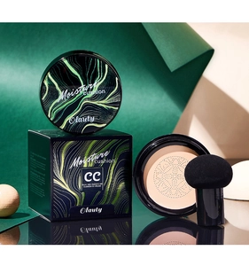 Detail of Olanty CC cream cushion foundation with black puff and sleek green packaging box
