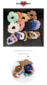 Macro shot of colorful pleated fabric scrunchies in vibrant pastel and earth tones